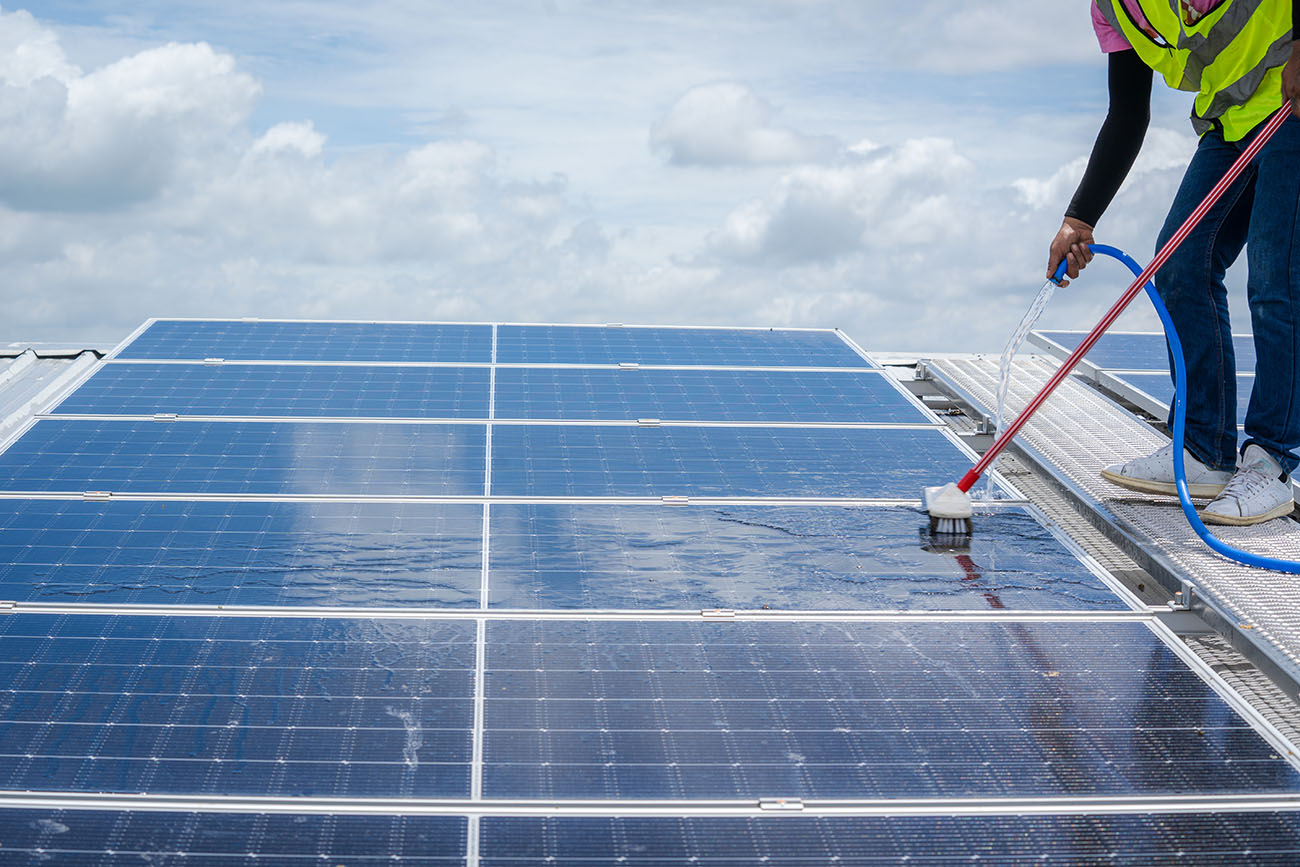 professional worker cleaning solar panels with bru 2023 08 18 06 48 15 utc